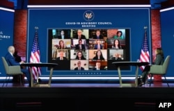 US President-elect Joe Biden (L) and US Vice President-elect Kamala Harris speak virtually with the Covid-19 Advisory Council during a briefing at The Queen theatre on November 9, 2020 in Wilmington, Delaware. (Angela Weiss / AFP)
