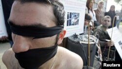 FILE - Syrian opposition members take part in a demonstration calling for more human rights in Syria, including putting a stop to physical torture in prisons, Beirut, Lebanon.