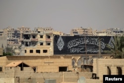 A banner belonging to Islamic States fighters is seen during a battle with members of the Syrian Democratic Forces in Raqqa, Syria, Aug. 16, 2017.