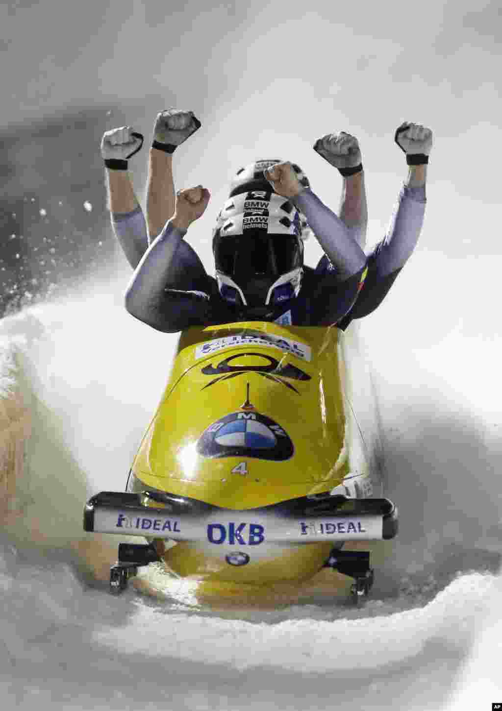 Driver Nico Walther, foreground, with Marko Huebenbecker, Christian Poser and Eric Franke, of Germany, celebrates after winning the four-man bobsled World Cup race, in Park City, Utah, USA, Jan. 16, 2016.