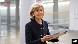 FILE - Sen. Kay Bailey Hutchison, R-Texas, walks to the floor of the Senate on Capitol Hill in Washington, Dec. 12, 2012, to give her farewell speech. 