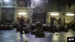 French military packing their bag aboard the French Navy amphibious assault ship BPC Dixmude moored in the port of Douala, Dec. 3, 2013.