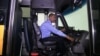 Tashitaa Tufaa drives one of his company's largest school buses, which seats 70 pupils, in Fridley, Minnesota, Aug. 9, 2017. Tufaa's company owns nearly 300 buses. (Photo: Abdi Mohamud for VOA)