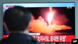 一名男子在韩国首尔火车站观看朝鲜试射导弹的电视资料画面。（2017年11月29日）