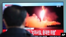 FILE - A man watches a TV screen showing a local news program reporting with a file footage of North Korea's missile launch, at the Seoul Railway Station in Seoul, South Korea, Nov. 29, 2017. 