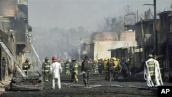 Emergency workers and firefighters work at the scene after a pipeline explosion in San Martin Texmelucan, Mexico, 19 Dec 2010