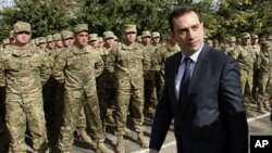 Georgian Defense Minister Irakli Alasania passes soldiers while visiting the Mukrovani military base, east of Tbilisi, Georgia, Nov. 7, 2012. 