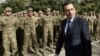 Georgian Defense Minister Irakli Alasania passes soldiers while visiting the Mukrovani military base, east of Tbilisi, Georgia, Nov. 7, 2012. 