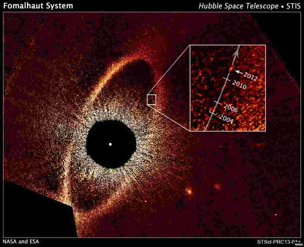 Newly released NASA Hubble Space Telescope images of a vast debris disk encircling the nearby star Fomalhaut and a mysterious planet circling it may provide forensic evidence of a titanic planetary disruption in the system. (NASA, ESA)