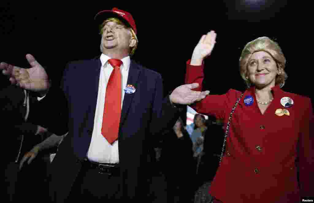 Supporters of Democratic U.S. presidential candidate Hillary Clinton, who came to her rally in costume as Republican presidential candidate Donald Trump and Clinton, attend her Super Tuesday night party in Miami, Florida, March 1, 2016. 