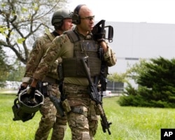 FBI agents walks at the industrial business park, where several people had been shot, according with police reports in Harford County, Sept. 20, 2018.