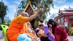 Monks from Wat Thai Los Angeles, offer blessings to visitor to the temple in Los Angeles, CA. Sunday, April 11, 2021, during the Songkran, Thai New Year Ceremony
