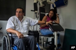 Javier Hernandez, a former employee of a state-run cement factory, and his wife, Denitza Colmenarez, a 39-year-old public-school teacher, are seen during an interview at their home in Guatire Venezuela, Aug. 3, 2017.