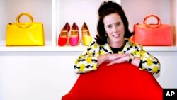 FILE - In this May 13, 2004 file photo, designer Kate Spade poses with handbags and shoes from her next collection in New York.