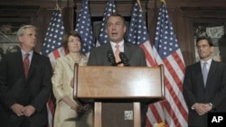 House Speaker John Boehner of Ohio, at podium, accompanied by members of the House Republican leadership, speaks during a news conference at The Republican National Committee on Capitol Hill in Washington, July 26, 2011
