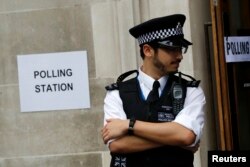 A policeman stands outside a polling station in central London, June 23, 2016.