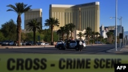 Crime scene tape surrounds the Mandalay Hotel (background) after a gunman killed at least 58 people and wounded hundreds of others after opening fire on a country music concert in Las Vegas, Nevada, Oct. 2, 2017.