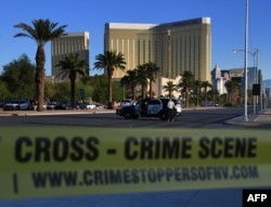 Crime scene tape surrounds the Mandalay Hotel (background) after a gunman killed at least 50 people and wounded more than 200 others when he opened fire on a country music concert in Las Vegas, Nevada, Oct. 2, 2017.