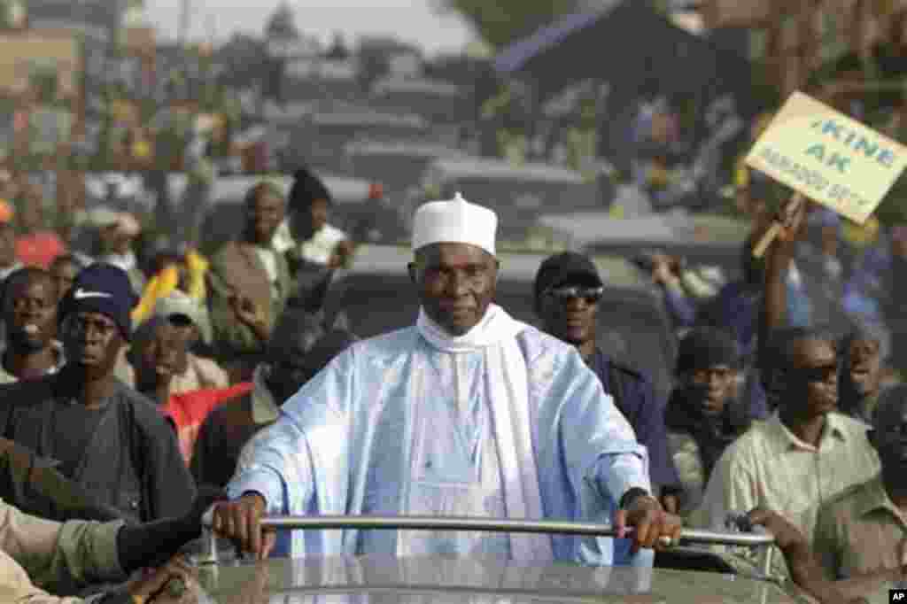 Senegalese President Abdoulaye Wade is surrounded by supporters and security as he travels between campaign stops in downtrodden suburban neighborhoods of Dakar, Senegal Wednesday, Feb. 22, 2012.