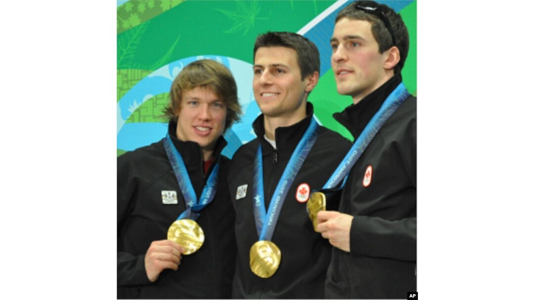 Mathieu Giroux, Lucas Makowsky, and Denny Morrison of Canada show off their gold medals in team pursuit speedskating in Vancouver, Canada, 27 Feb 2010