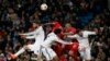 Liverpool and Real Madrid players jump for a ball during their Champions League Group B soccer match in Madrid November 4, 2014. 