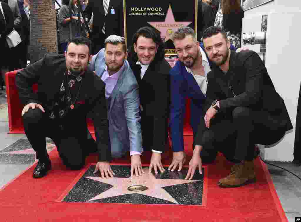 From left, Chris Kirkpatrick, Lance Bass, JC Chasez, Joey Fatone and Justin Timberlake of the band NSYNC appear at a ceremony honoring them with a star on the Hollywood Walk of Fame, April 30, 2018, in Los Angeles, California.