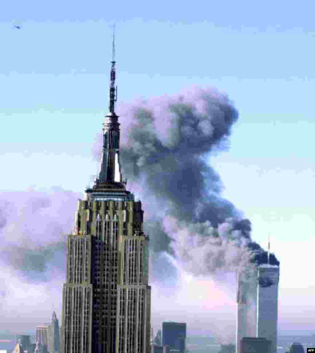 Plumes of smoke pour from the World Trade Center buildings in New York Tuesday, Sept. 11, 2001. Planes crashed into the upper floors of both World Trade Center towers minutes apart Tuesday in a horrific scene of explosions and fires that left gaping holes