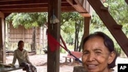 Im Chaem, a former Khmer Rouge commander, holds her grandson at her home in Anlong Veng district, in Cambodia's Oddar Meanchey province, where she is a first deputy commune chief. 