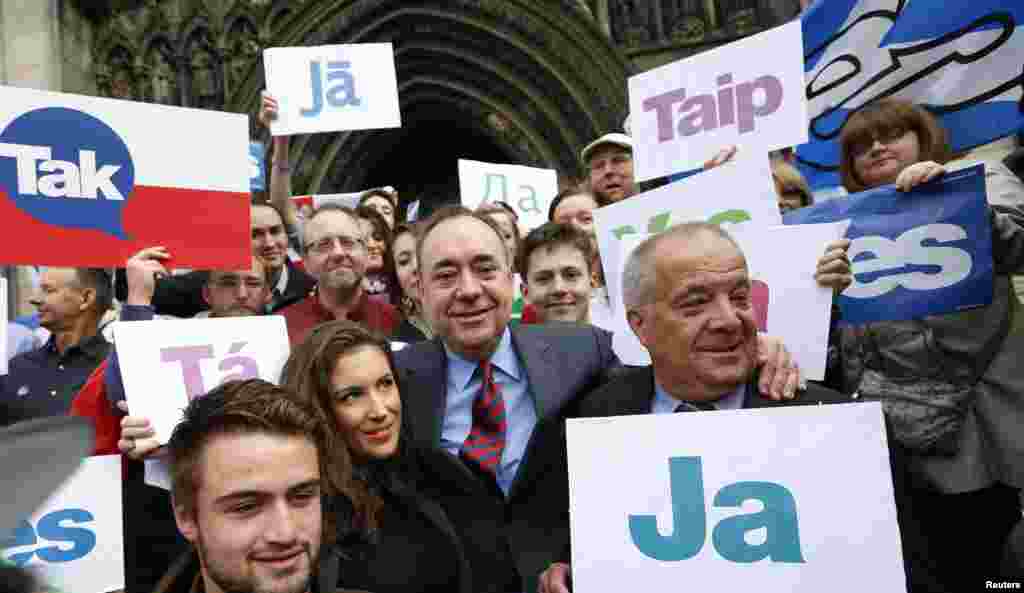 Scotland's First Minister Alex Salmond, center, poses with supporters of the "Yes Campaign" in Edinburgh, Scotland, Sept. 9, 2014. 