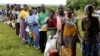 FILE—Malawians queue for food aid distributed by the United Nations World Food Program in Mzumazi village near the capital Lilongwe, February 3, 2016. 