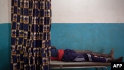 FILE - A young man wounded by gunshot is treated at Paoua's hospital, northwestern Central African Republic, Dec. 28, 2017. 