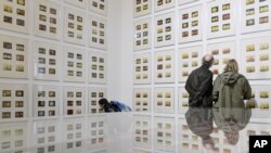 FILE - People stand in front of 372 drawings with the title '1912-60s' of German artist Korbinian Aigner during the press preview of the dOCUMENTA (13)in Kassel, Germany, June 6, 2012.