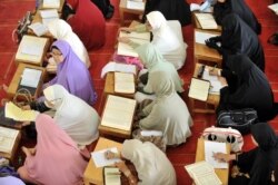 Indonesian Muslim women attend a sermon at a mosque