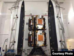 This is a photo of the first 10 Iridium NEXT satellites, inside the SpaceX “dispenser,” the payload fairing used to protect the satellites during the rocket launch. (Credit: Iridium)