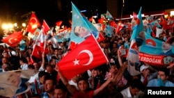 Supporters of Turkey's Prime Minister Recep Tayyip Erdogan celebrate his election victory in front of his party's headquarters in Ankara August 10, 2014.