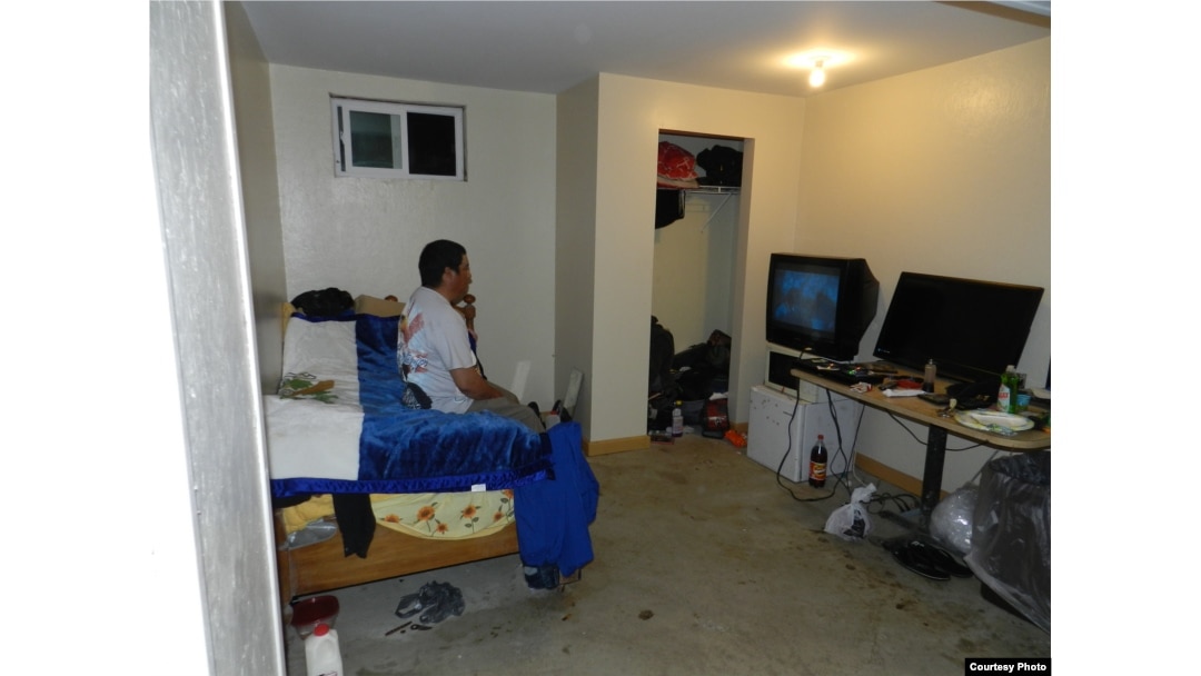 Guillermo Peralta sits in his basement apartment in York Springs, Pennsylvania. (Photo courtesy of Mike Kornely)