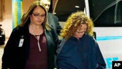 Tonya Couch, second from right, is escorted into Tarrant County Jail in Fort Worth, Texas, Jan. 7, 2016. 