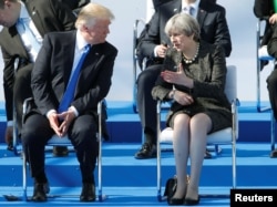 U.S. President Donald Trump and Britain's Prime Minister Theresa May during a ceremony at the new NATO headquarters before the start of a summit in Brussels, Belgium, May 25, 2017.