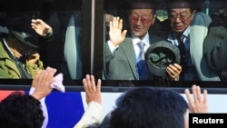 South Koreans on a bus bid farewell to their North Korean relatives after temporary family reunions at Mount Kumgang resort in North Korea, in this November 5, 2010, file photo.