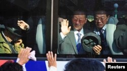 South Koreans on a bus bid farewell to their North Korean relatives after temporary family reunions at Mount Kumgang resort in North Korea, in this November 5, 2010, file photo.