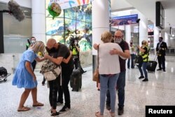 People reunite at Sydney Airport in the wake of COVID-19 border restrictions easing, with fully vaccinated Australians being allowed into Sydney from overseas without quarantine for the first time since March 2020, in Sydney, Australia, November 1, 2021.