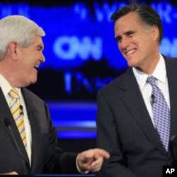 Former Massachusetts governor Mitt Romney, right, answers a question during the first New Hampshire Republican presidential debate on June 13, 2011.