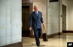 FILE - Longtime Donald Trump associate Roger Stone arrives to testify before the House Intelligence Committee, on Capitol Hill in Washington, Sept. 26, 2017.