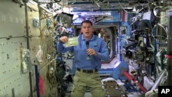 FILE - In this image taken from NASA video recorded Nov. 18, 2016, NASA astronaut Shane Kimbrough shows a pouch of turkey he will be preparing for his crew in celebration of the Thanksgiving holiday, aboard the International Space Station.