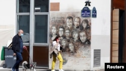Портрети розстріляних журналістів Charlie Hebdo на стіні будівлі у Парижі