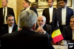 Iranian Foreign Minister Mohammad Javad Zarif, center right, speaks with Belgian Foreign Minister Didier Reynders during a meeting at the Egmont Palace in Brussels, Jan. 11, 2018. European Union foreign ministers held separate talks with their Iranian counterpart in Brussels amid doubts over the future of an international agreement curbing the Islamic Republic's nuclear ambitions.