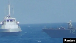 An Iranian vessel steers close to the U.S. Navy coastal patrol craft USS Thunderbolt (R) in the Persian Gulf in a still image from video provided by the U.S. Navy, July 25, 2017.