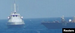 An Iranian vessel steers close to the U.S. Navy coastal patrol craft USS Thunderbolt (R) in the Persian Gulf in a still image from video provided by the U.S. Navy, July 25, 2017.