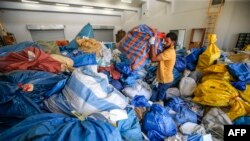 A Palestinian postal worker sifts through sacks of previously undelivered mail dating as far back as 2010, which has been withheld by Israel, at the central international exchange post office in the West Bank city of Jericho on Aug. 14, 2018.