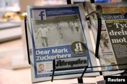 FILE - The front page of Norway's Aftenposten is seen at a news stand in Oslo, Norway, Sept. 9, 2016. The newspapers chief editor accused Facebook of abusing its power after it deleted an 1972 iconic image of a nude Vietnamese girl running from a napalm attack.